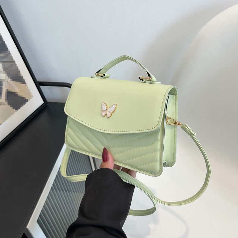 Simple Crossbody Bag in pastel green with butterfly clasp top handle detachable strap quilted front