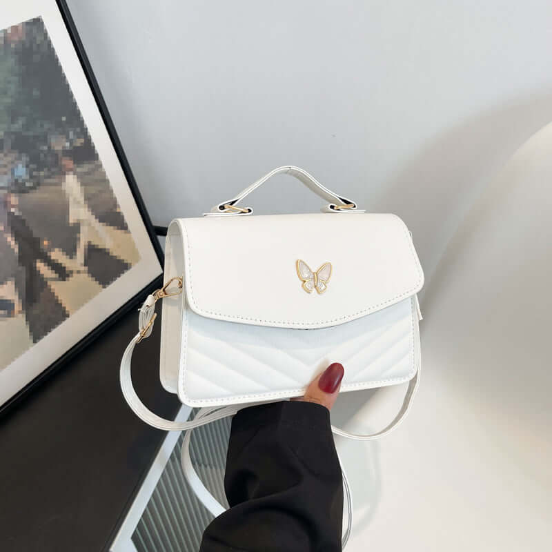 White leather Simple Crossbody Bag with gold butterfly emblem quilted front and top handle