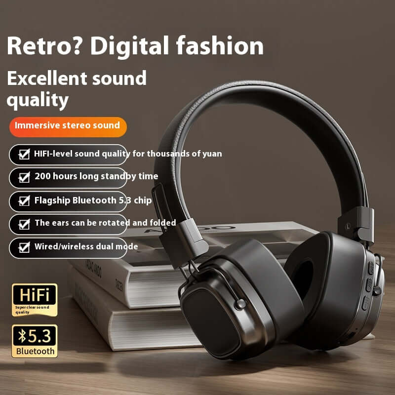 Black 40mm driver bluetooth headset with foldable ears and wired wireless dual mode on wooden table
