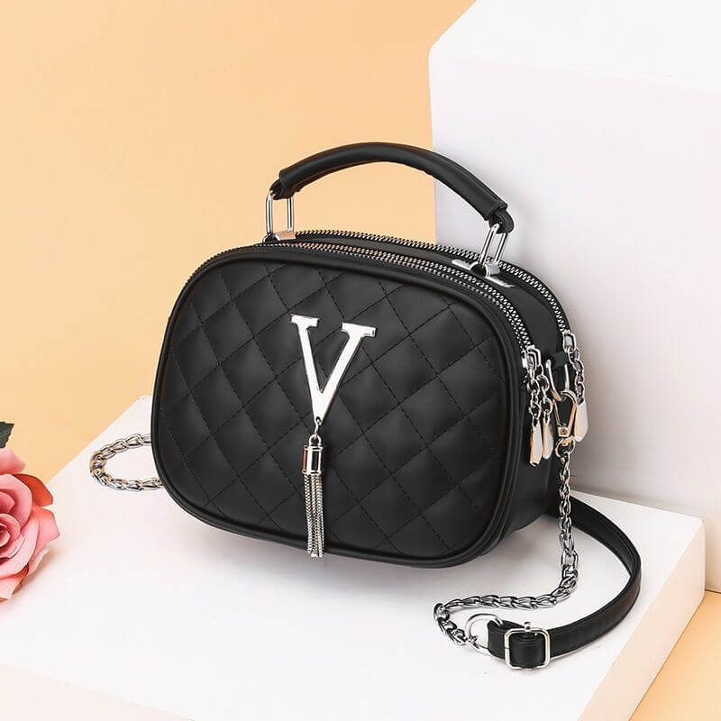 Black quilted one shoulder handbags for women with silver V charm and chain strap
