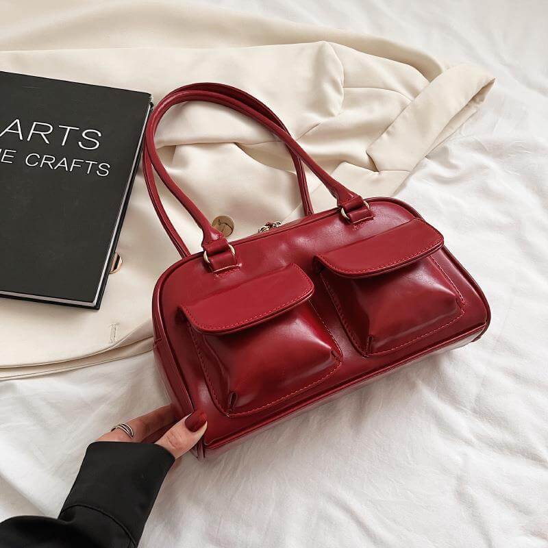 Red stylish work handbag for women with double front pockets and sturdy handles on cream fabric
