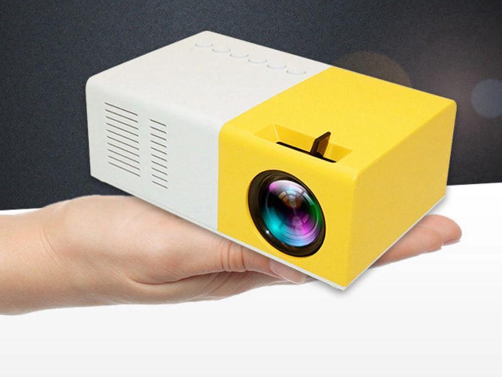 The compact Ultra HD Mini Projector by Ecom brands is held in a hand, showcasing its portability and user-friendly design, perfect for on-the-go movie nights. ares-projector