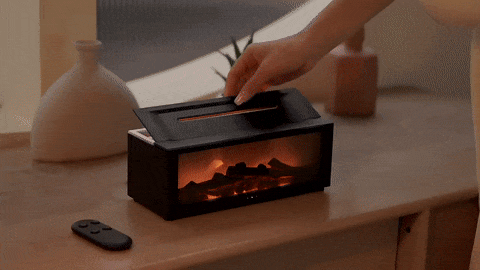 User interacting with the Fireplace Humidifier, opening the top lid to reveal its mist output capabilities, demonstrating its user-friendly features.