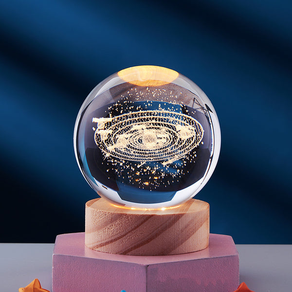 3D Crystal Ball Night Light featuring a glowing solar system design on a wooden base, perfect for creating a warm atmosphere.