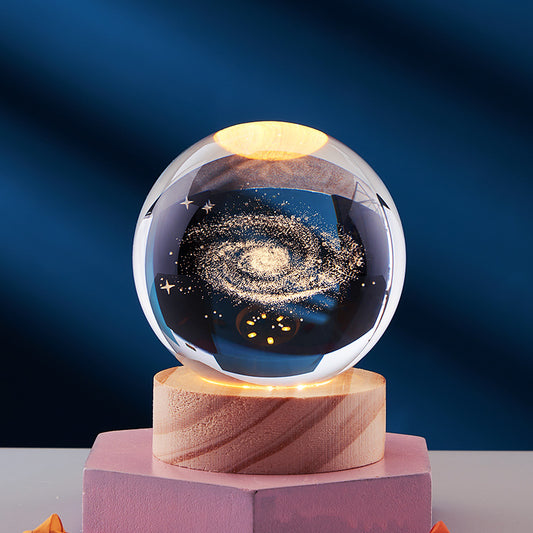 3D Crystal Ball Night Light showcasing a beautiful galaxy design illuminated, ideal for bedtime ambiance.