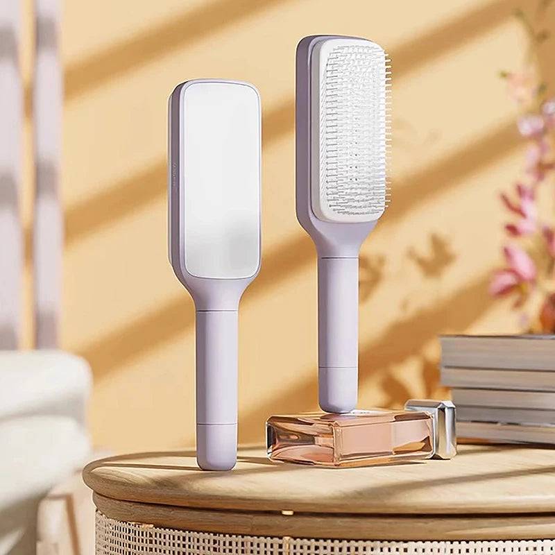 Self-Cleaning Brush by CozyTech Living displayed in a well-decorated setting, emphasizing its elegant design alongside a stylish perfume.