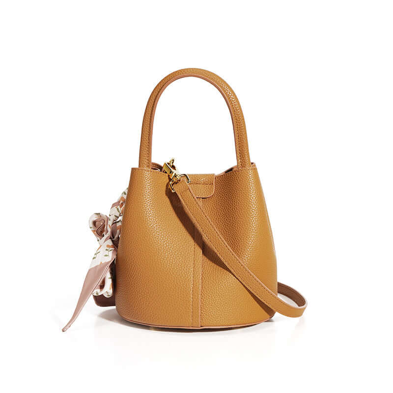 Genuine Leather Advanced Texture Bucket Bag for Women, shown in a warm brown color, complemented with a chic scarf, ideal for everyday outings as a genuine leather handbag.