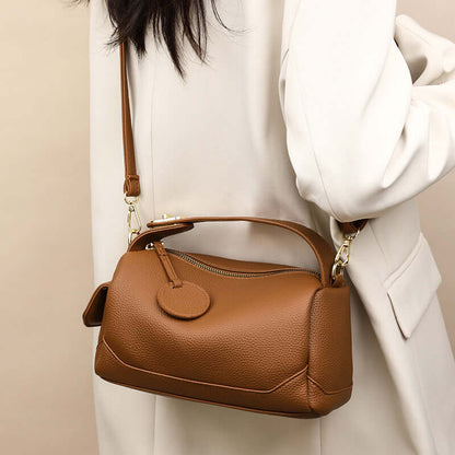 Crossbody Soft Leather Large Capacity Pillow Bag - A model wears a brown fashionable handbag for women, showcasing the convenient shoulder strap.