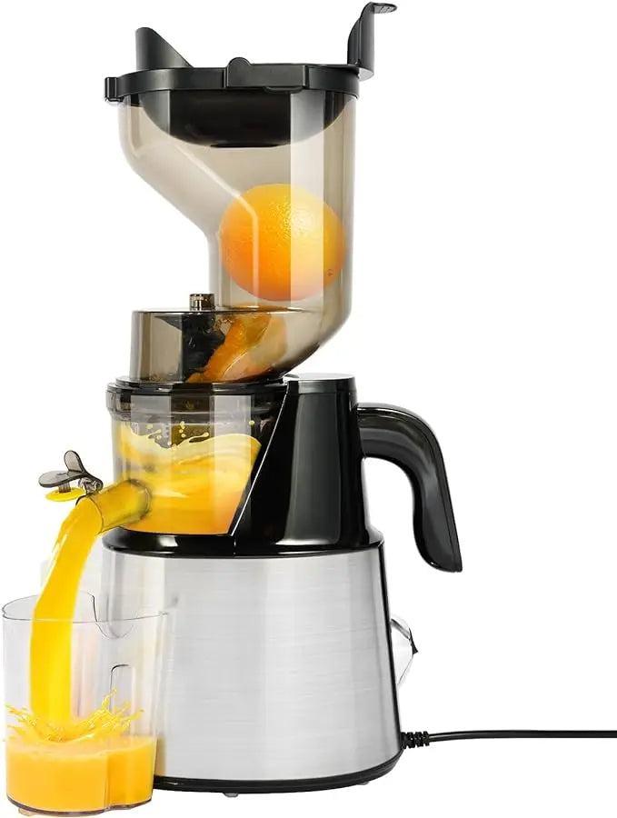 Cold press masticating juicer with a stainless steel base, extracting fresh orange juice. Features a large feed chute for whole fruit processing.