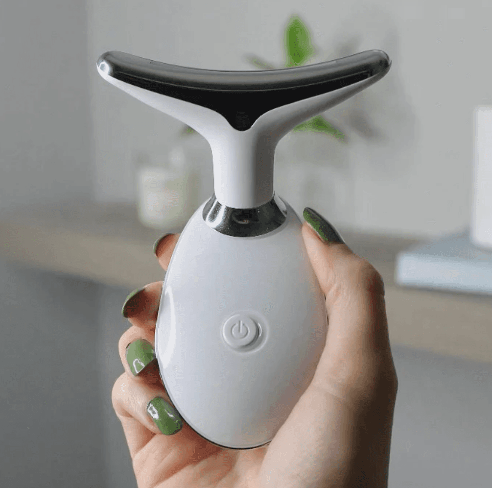 The Pure Aura Micro Glow Massager held by a user, demonstrating its portable design and efficiency in skincare routines. This model is part of the lumiglow, lumiglow pro collection.