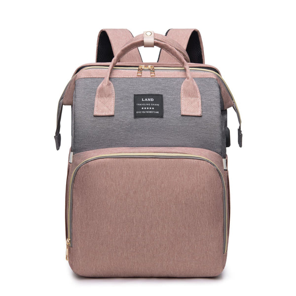 Front view of New Mummy Baby Crib Backpack in pink color, showcasing its large capacity and stylish design, perfect for mothers on the go.