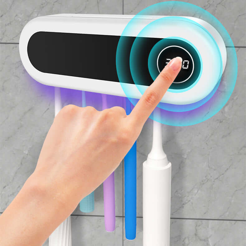 Close-up of a hand pressing a button on the Wall Mounted Toothbrush Sterilizer Holder with UV Disinfection and Toothpaste Dispenser, featuring a digital display, highlighting the convenient functionality of the toothbrush sterilizer holder.