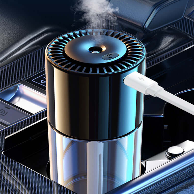 Sleek black AI powered fragrance dispenser with USB charging in a car cup holder releasing mist