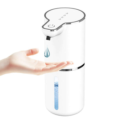 White automatic soap dispenser touchless releasing soap onto a hand with water level indicator
