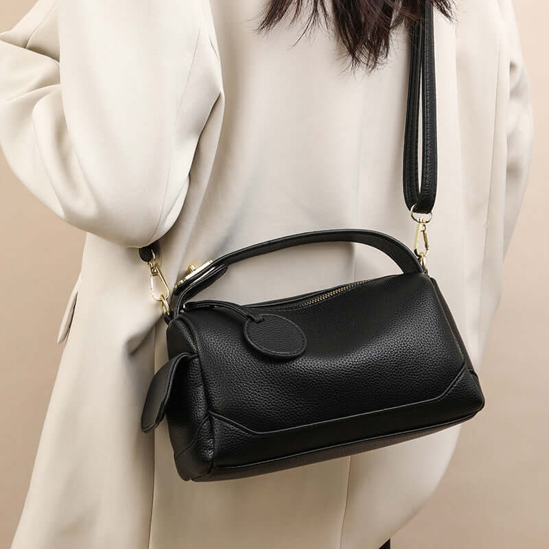 Crossbody Soft Leather Large Capacity Pillow Bag - A stylish black handbag for women displayed on a model's shoulder, highlighting its anti-style and practicality.