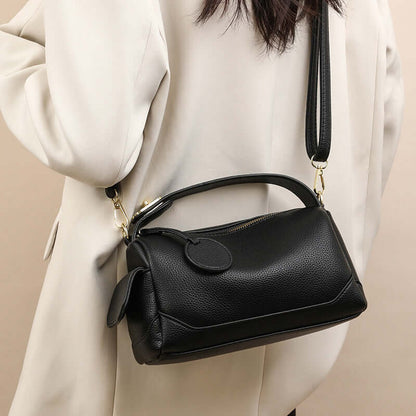 Crossbody Soft Leather Large Capacity Pillow Bag - A stylish black handbag for women displayed on a model's shoulder, highlighting its anti-style and practicality.