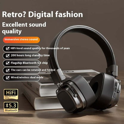 Black 40mm driver bluetooth headset with foldable ears and wired wireless dual mode on wooden table