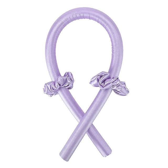 Lavender Heatless Curling Rod Headband displayed with accessories, showcasing its stylish design. A gentle hair styler that delivers beautiful curls while you sleep, with no heat involved. Tags: beauty, curler, hair styler.