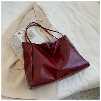 Fashion Handbag New Autumn And Winter Japanese And Korean Large Capacity Soft Leather Shoulder Bag showcased in wine red color on a light surface.