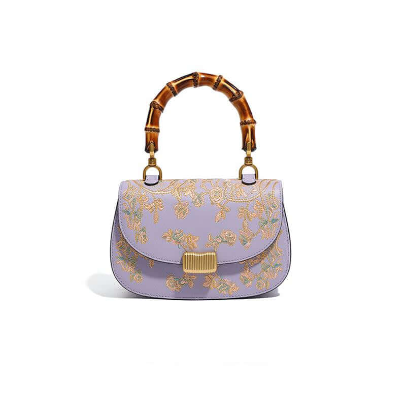 Stylish Cowhide Leather Handbag with Exquisite Embroidery and Bamboo Handles for Women - Front view of a lavender cowhide leather handbag adorned with exquisite embroidery and a bamboo handle.