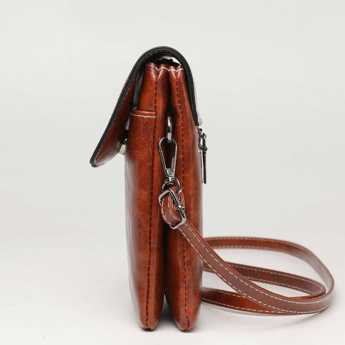 Side view of the Fashion Simple Large Capacity Mobile Phone Bag Mini Crossbody Bag in brown, highlighting its slim design and multiple compartments. An essential fashionable mini bag.