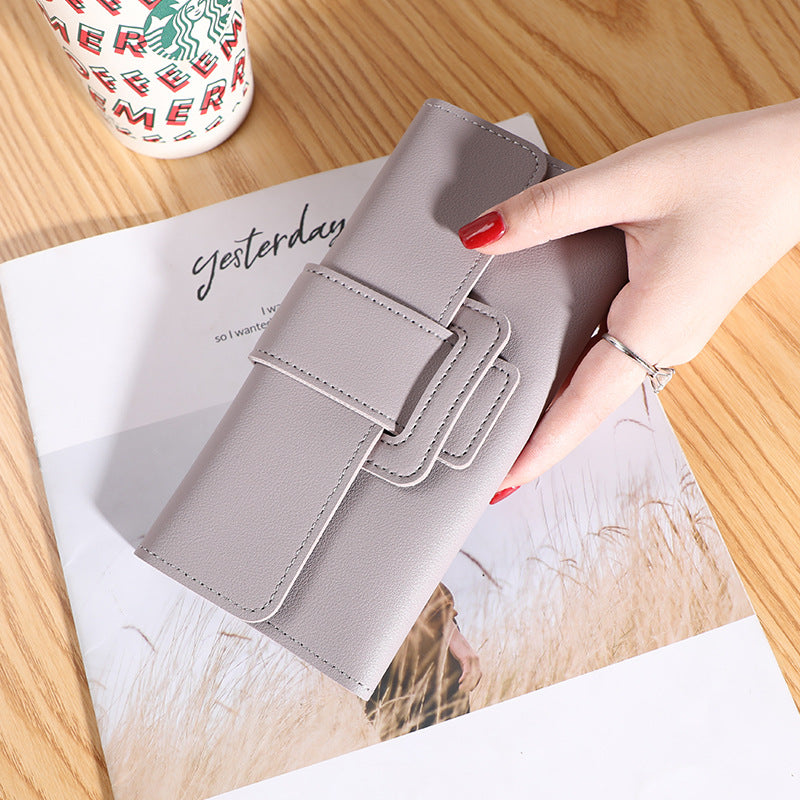 Women's Long Wallet Tri-fold Clutch in soft gray color, emphasizing large capacity with a chic appearance.
