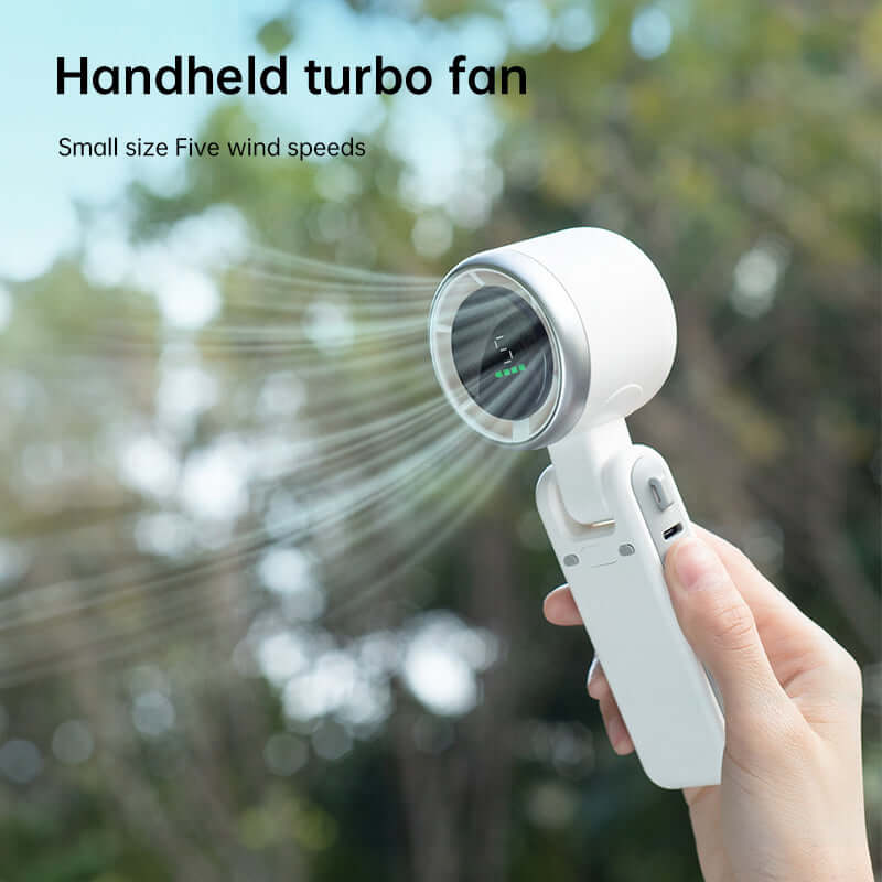Handheld foldable electric fan for travel with five wind speeds in white held outdoors