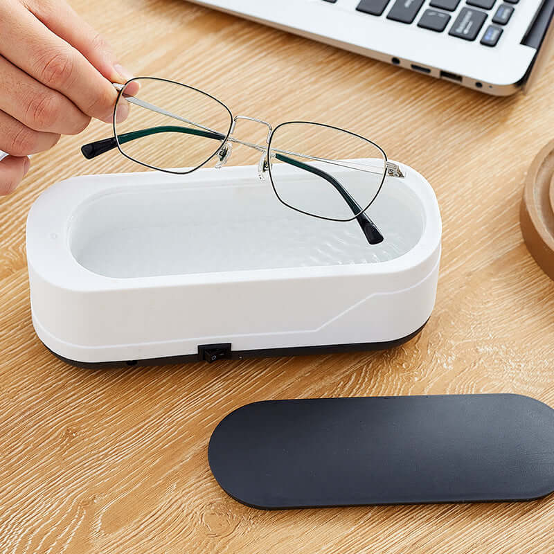 CozyTech Living ultrasonic eyeglasses cleaner with metal frame glasses being placed inside for cleaning