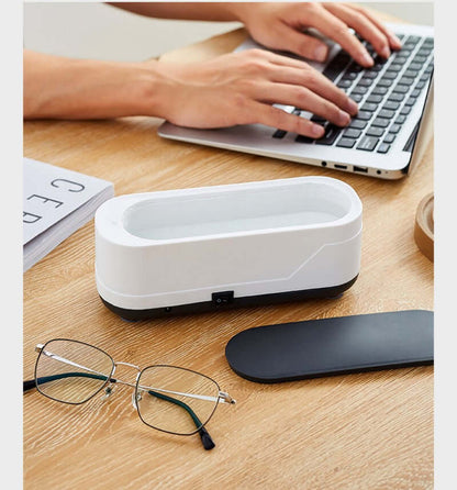 CozyTech Living ultrasonic eyeglasses cleaner on desk next to glasses and laptop in use