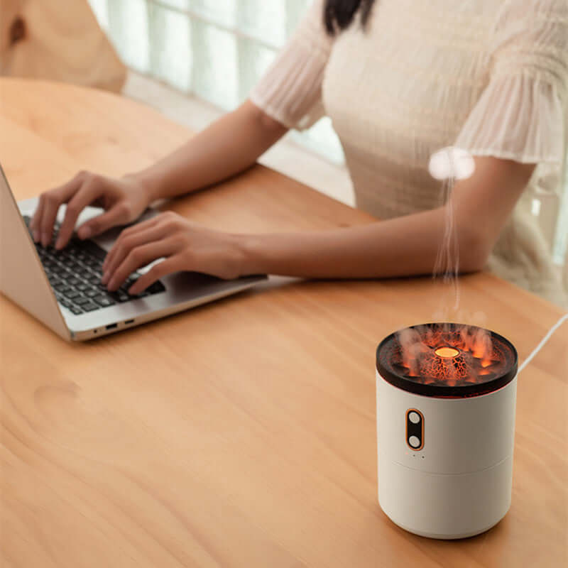 Woman working at a table with Jellyfish Style Humidifier, illustrating its functionality as an essential oil diffuser in a home office setting.