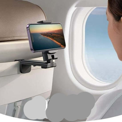 Foldable phone holder for travel mounted on airplane seat with phone displaying scenic view