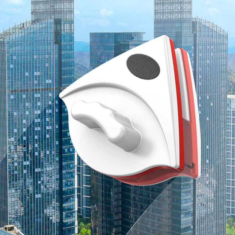 CozyTech Living magnetic glass cleaner in white and red with ergonomic handle against city skyscraper background