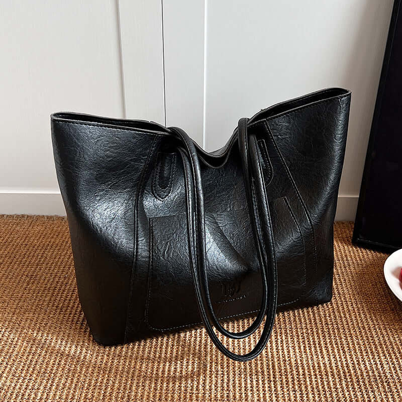 Casual Retro Shoulder Bag Texture Class Commuter Tote capturing a sleek black medium soft tote bag, enhanced with stylish handles.