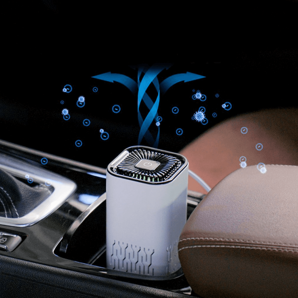 Portable car air freshener ionizer placed in car cup holder emitting fresh air particles