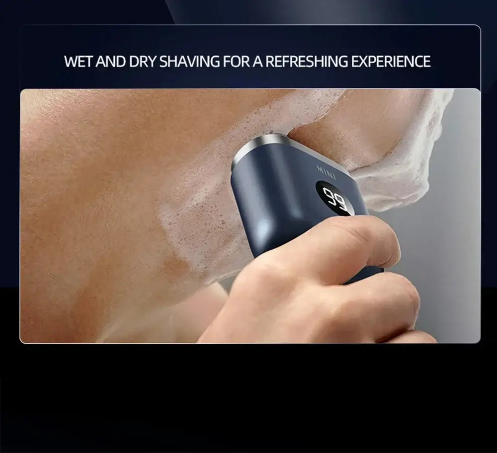 Person using a portable electric shaver for men with wet shaving foam on the face