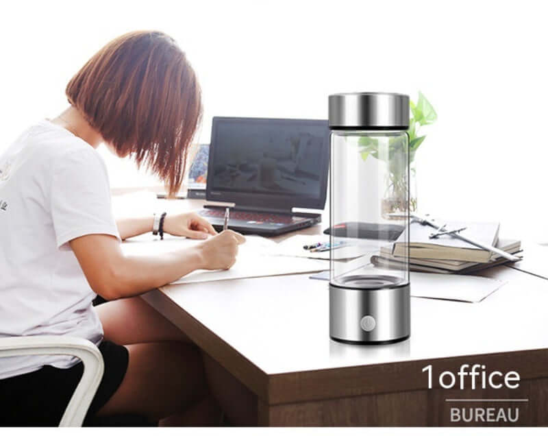 Dropshipman portable hydrogen water bottle on office desk next to laptop and notebook