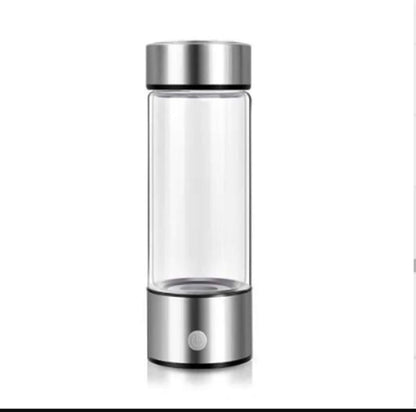 Portable hydrogen water bottle with clear glass body and silver metallic top and base by Dropshipman