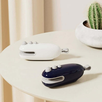 Two compact Portable Sealing Devices in white and navy placed on a round table next to a cactus plant