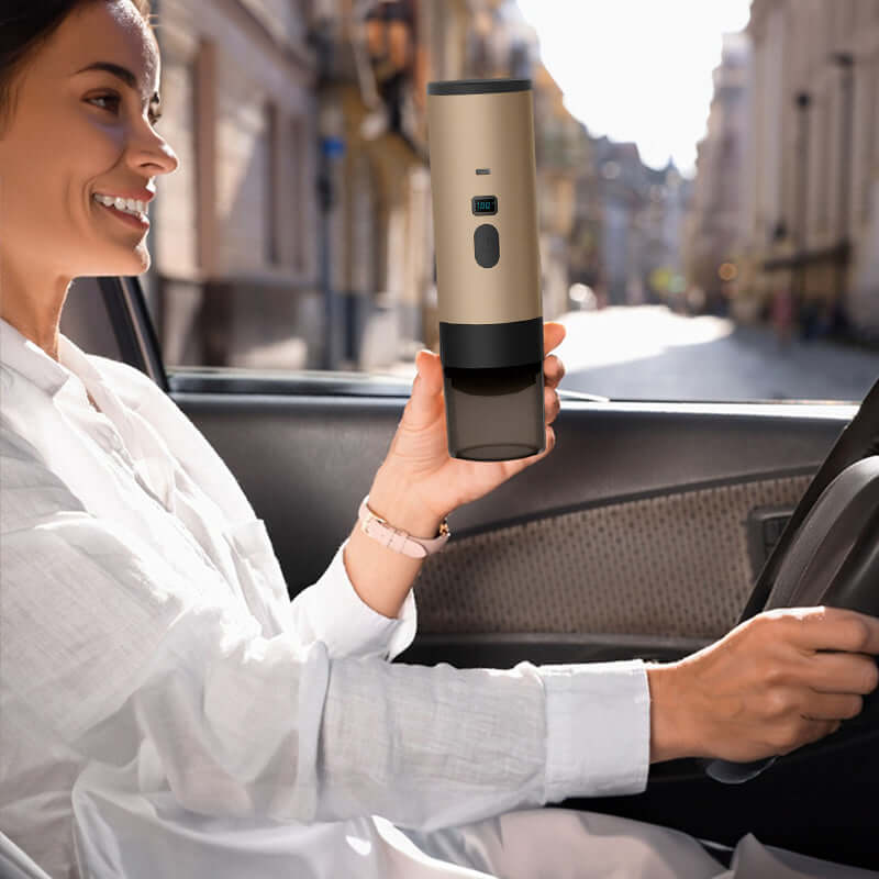 Woman driving while holding the Portable Espresso Maker with 7800mAh Battery, showcasing its convenience for on-the-go espresso drinking.
