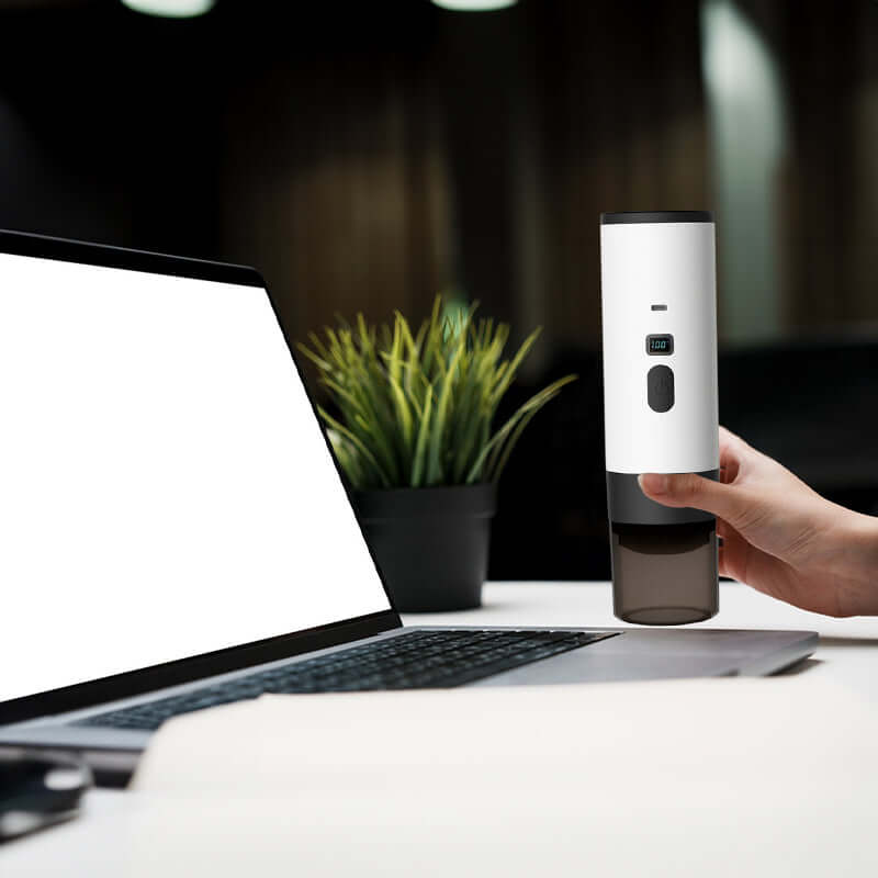 User enjoying the Portable Espresso Maker with 7800mAh Battery at a workspace, highlighting its practicality for on-the-go brewing.