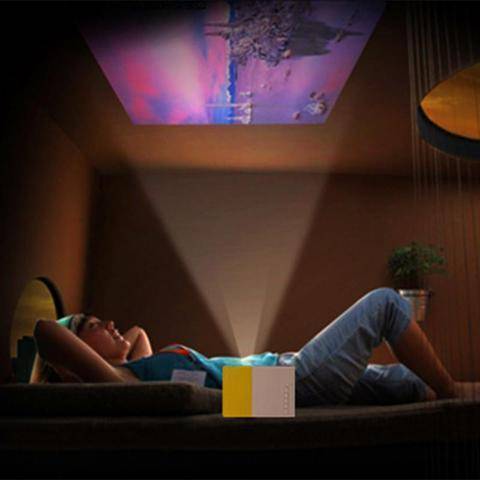 A cozy scene featuring the Ultra HD Mini Projector by Ecom brands projecting images onto a ceiling, enhancing a relaxed viewing experience. ares-projector