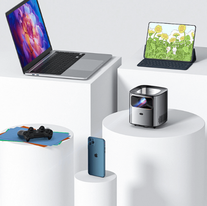 Dropshipman smart projector for living room displayed with laptop tablet phone and game controller on white pedestals