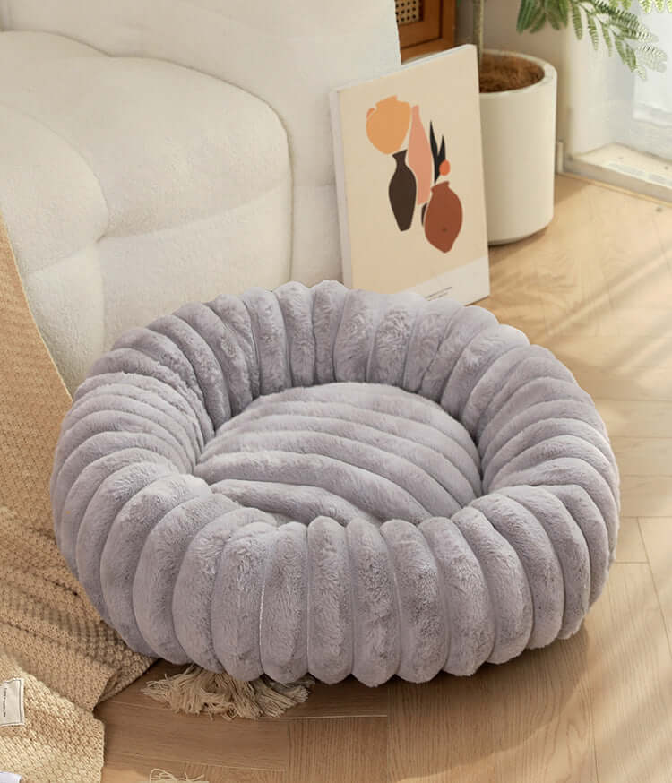 Grey super soft pet sleeping mat with plush texture in cozy living room setting