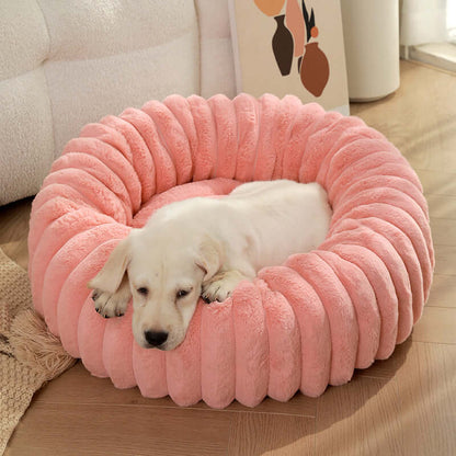 White puppy resting on a pink super soft pet sleeping mat in a cozy indoor setting