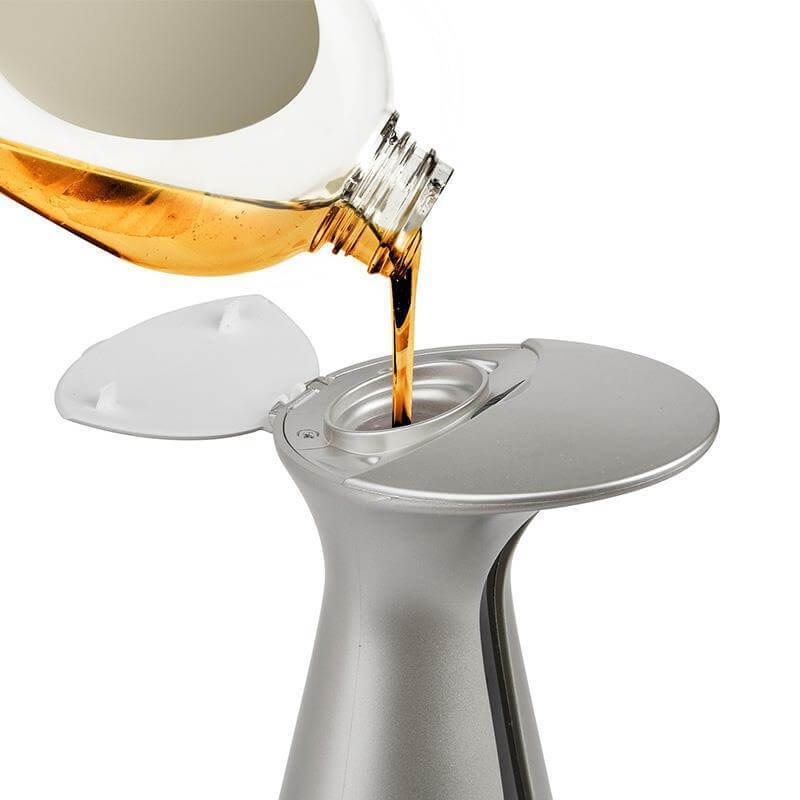 Refilling modern induction hand soap dispenser with liquid soap in silver finish