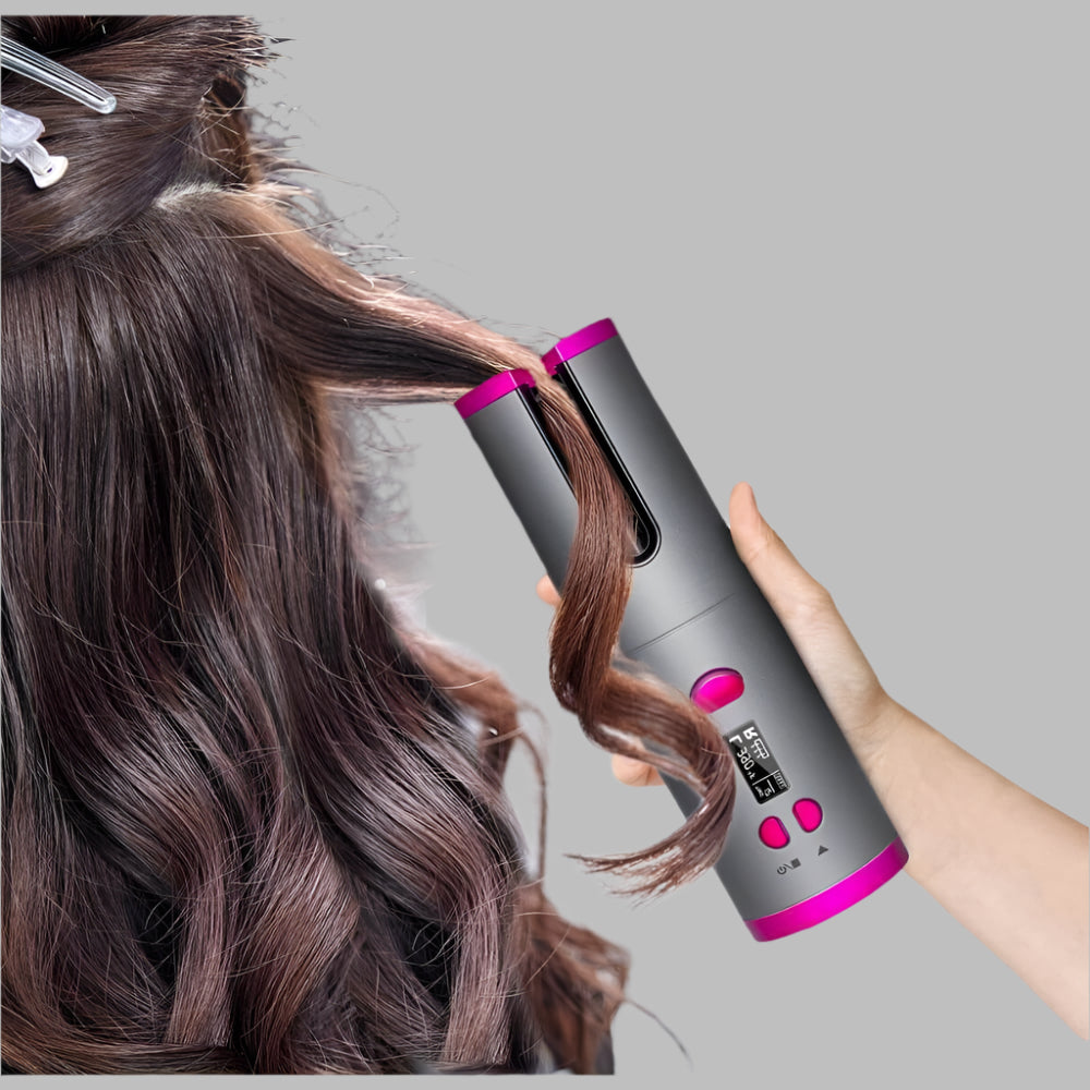 Wireless automatic curling iron styling long brown hair with digital display and pink accents